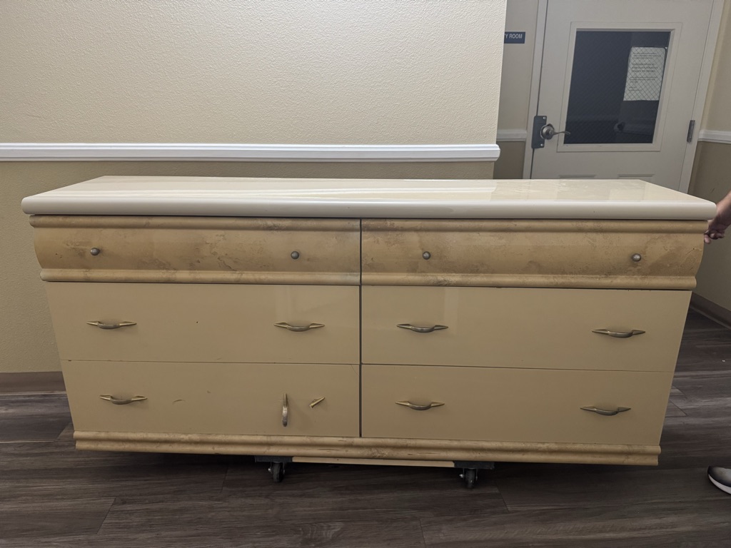 Free Six-drawer wooden dresser with a cream-tone finish and gold handles.